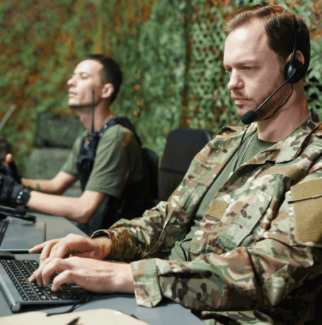 A team reviews a world map and 100-language list, coordinating Military Translation Services for global operations.