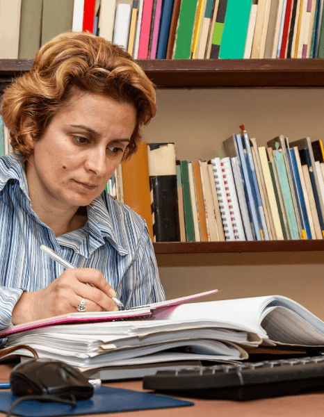 Registrar reviews a bilingual transcript as Georgian translation services preserve academic wording and GPA details.