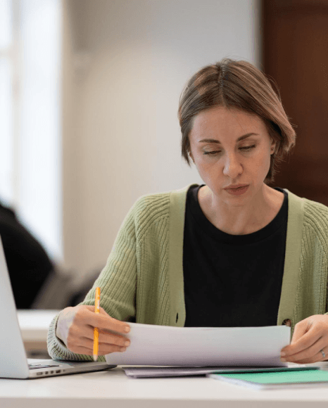 A student scans a university transcript as Macedonian translation services format educational course titles for evaluation.