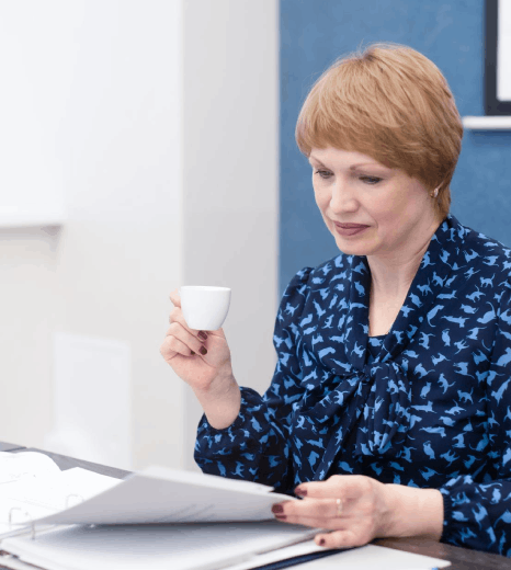 A researcher compares a journal article draft and the Norwegian source as Norwegian translation services keep terms.