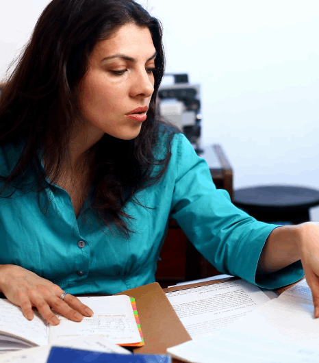 A researcher compares a Thai journal draft with edits, using Thai translation services to keep academic terms consistent.