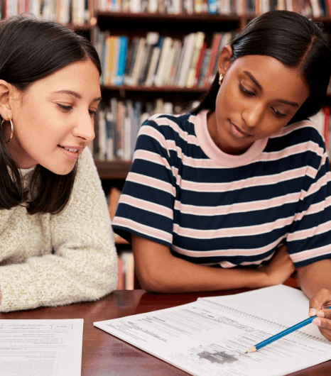 Two students review a Swedish transcript beside a grade scale chart as Swedish translation services align course titles.