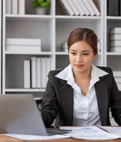 A translator compares a balance sheet and notes to finalize reports, delivering Accounting Translation Services for accuracy.