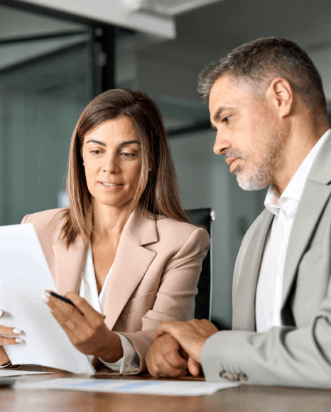Translators match column layouts and signature blocks while proofreading a lease agreement translation for accuracy.