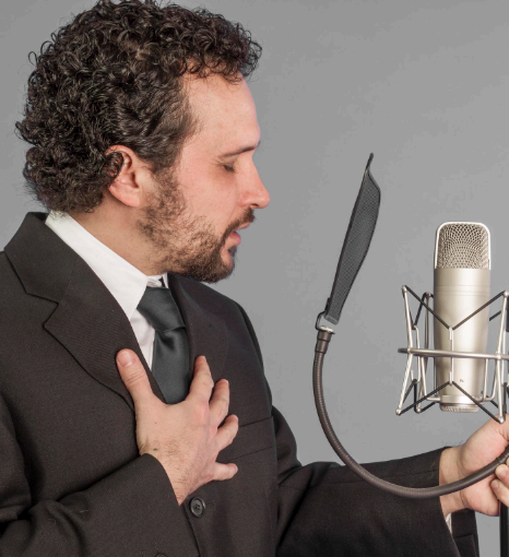 A localization lead reviews a script while German Voice Over Services record culturally relevant phrasing for an app launch.