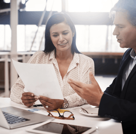 An ATA-certified linguist works at a desk translating an exclusion clause as insurance translation services ensure accuracy.