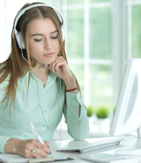 A subtitler studies a DACH audience report while checking subtitle drafts, aligning german subtitling services to regions.
