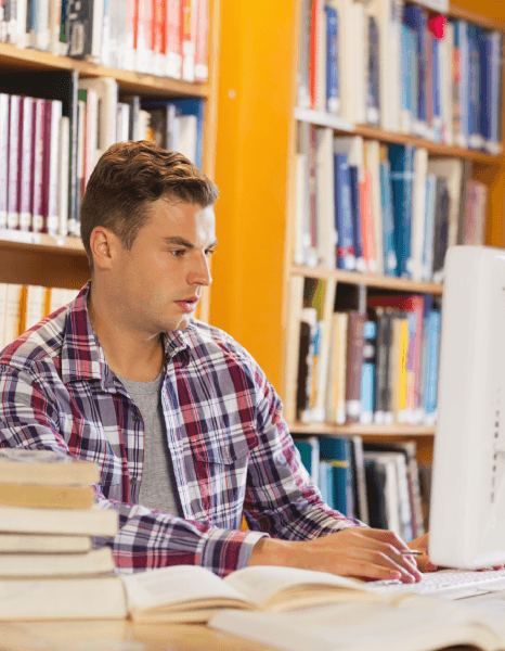 Student using translated academic materials, benefiting from university outreach programs aimed at international students.