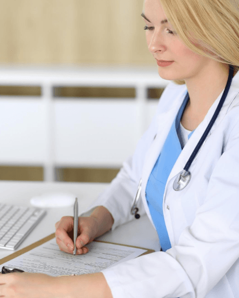 A billing specialist compares claim fields to dictation as medical transcription services create workflow-ready.