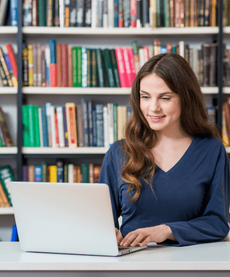 A client reviews a bilingual biography draft on screen as Biography Translation Services complete the process review.