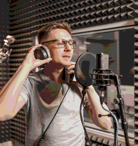 A native talent records Spanish Voice Over Services in a sound booth, delivering fast turnaround for an ad spot.