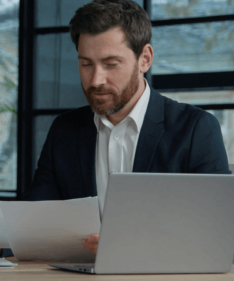 A manager compares clauses in a contract draft, using Bulgarian translation services to align corporate terms and approvals.