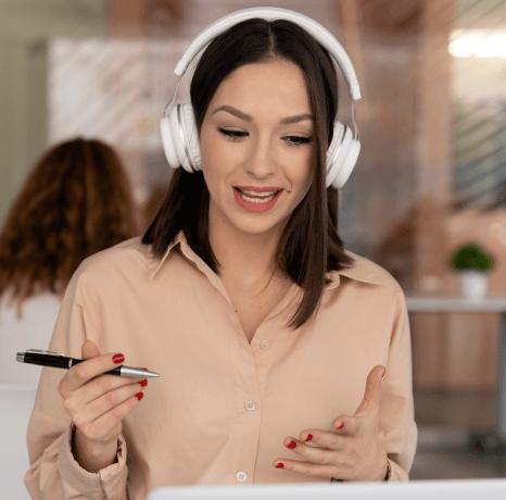 An HR manager reviews onboarding clips as corporate video captioning services add business captions for new hires.