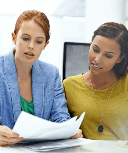 Executives review translated balance sheets in a boardroom, relying on financial statement translation for global business.