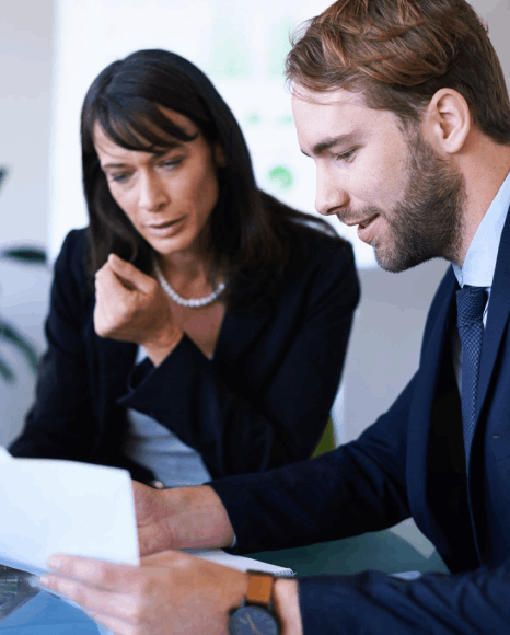 A legal team checks clauses and pricing in a bilingual draft, using Finnish translation services for business contracts.