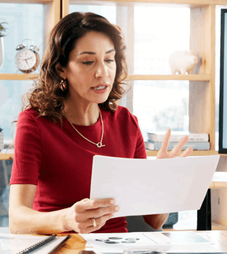 A compliance reviewer checks a business financial report after Language Typesetting Services standardize spacing.