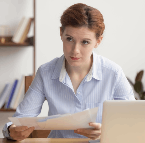 A project manager reviews contract clauses and a glossary, using Norwegian translation services for business agreements.