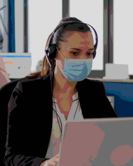 A project manager reviews a meeting audio file while Polish Transcription Services create a business transcript.