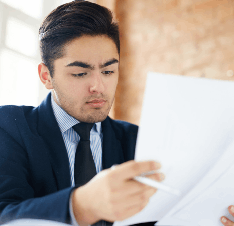 A contracts specialist compares clauses as Tibetan translation services translate a corporate agreement for a new.