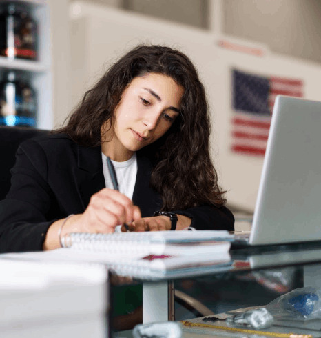 An HR lead reviews bilingual employee files as Ukrainian Translation Services format business records for hiring.