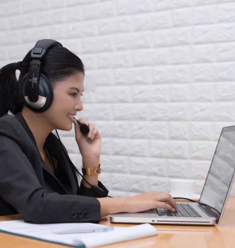 A call center manager reviews IVR scripts as Telephone Voiceover Services are recorded for clear, friendly phone audio.