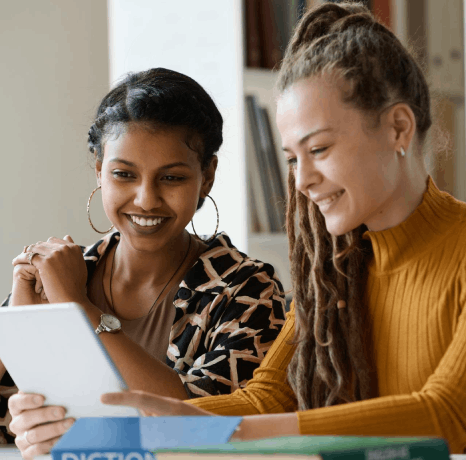 Two students scan transcripts for certified Basque translation services, checking names, credits, and grades for submission.