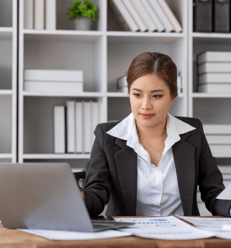 A certified translator checks names and dates on a biography packet for official use with Biography Translation Services.