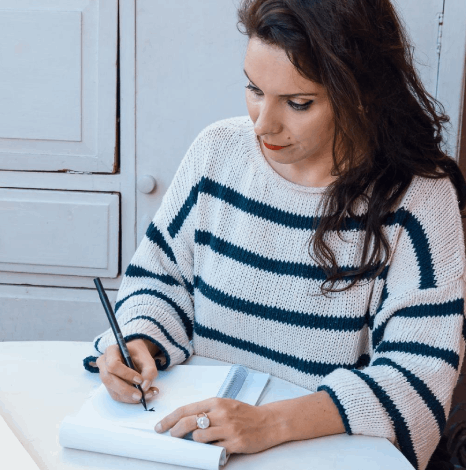 A translator signs a Certificate of Accuracy for a USCIS file, completing certified french translation services.