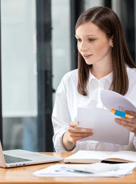 A reviewer checks names and stamps on a certified immigration document for Quick Translation Services to meet USCIS rules.