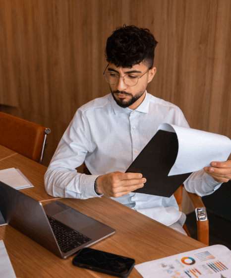 A certified translator checks a lease agreement translation for a rental contract, matching clauses before client delivery.