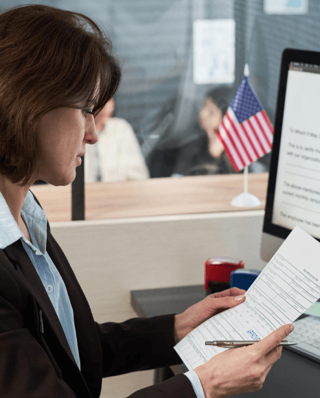 A certified translator compares a birth record to a passport while Macedonian translation services verify consistent.