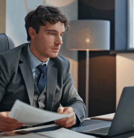 A business man formats a certified diploma translation for a degree evaluation, using spanish translation services new york.