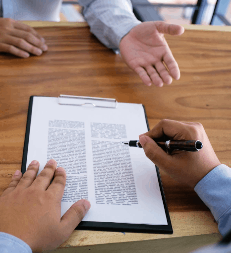 A notary signs and seals a certified packet completed with Ukrainian Translation Services for official legal submission.