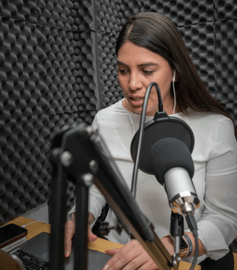 In a studio booth, a narrator delivers Portuguese Voice Over Services with clear and engaging audio for eLearning.