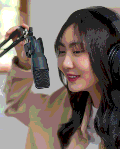 A producer monitors levels as clear, engaging audio is recorded for Korean Voice Over Services in a studio booth.