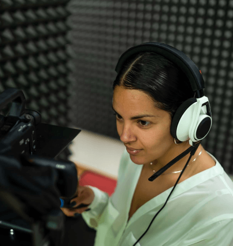 A project manager reviews revisions to ensure clear multilingual audio for a voice over service for museum tour delivery.