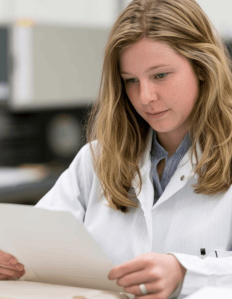 A project manager prepares pharmaceutical clinical trial packets with healthcare translation services for multi-format.