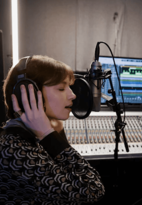 A voice artist recording a commercial voiceover in a sound studio. A voice artist recording a commercial voiceover in a sound studio.