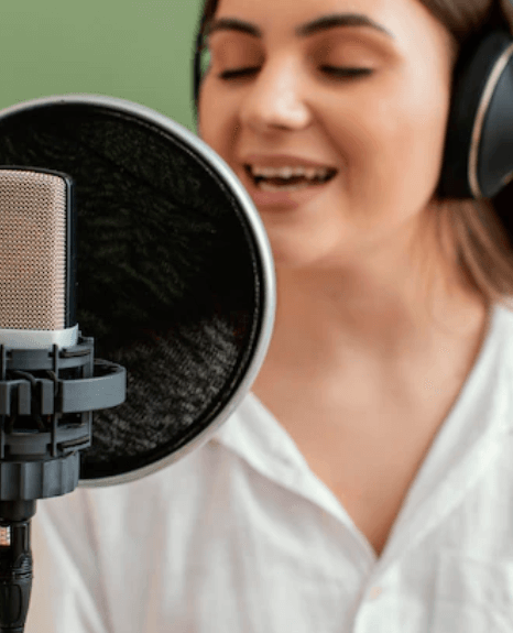 A young French voice artist with microphone recording a trial voiceover. A young French voice artist with microphone recording a trial voiceover.