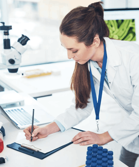 A linguist verifies complex scientific terms in a biotech report, using life sciences translation services for accuracy.