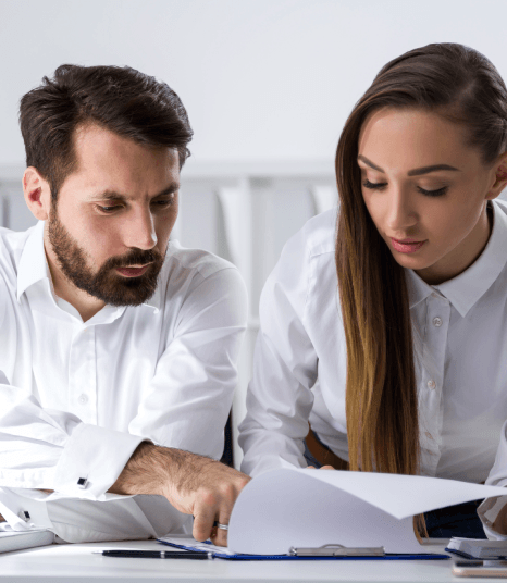 A compliance officers checks bilingual audit reports while using Accounting Translation Services to meet cross-border rules.