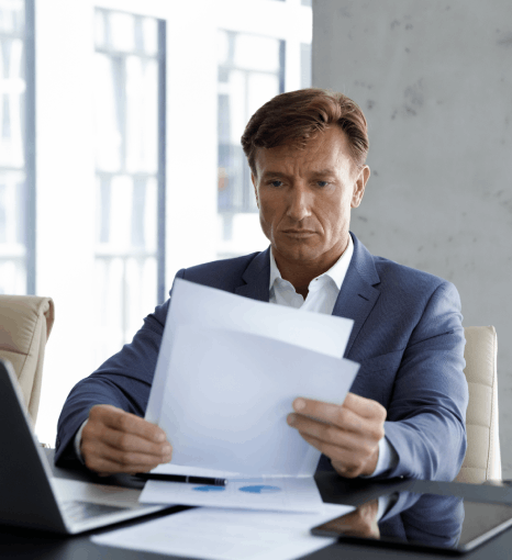 A translator marks clauses in a comprehensive contract pack as corporate document translation services reduce dispute risk.