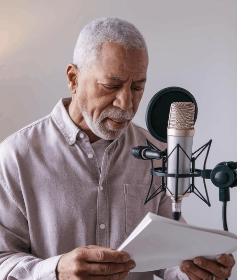 A client reviews Voice Over Styles for content needs as a narrator records a corporate video script in a booth.