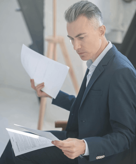 A paralegal compares a bilingual contract and highlights clauses while Afar translation services ensure legal accuracy.