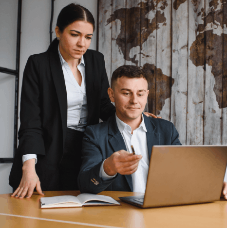 An editors review a contract on a laptop as one hour translation services return a formatted version before a meeting.