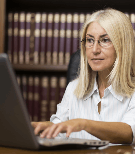A lawyer compares a Czech contract to its English draft as Czech translation services preserve defined terms and clauses.