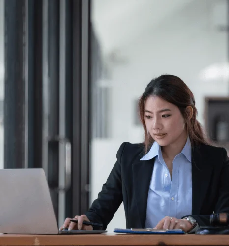 A lawyer reviews contract clauses on a desk while Quick Translation Services prepares a legal translation for filing.