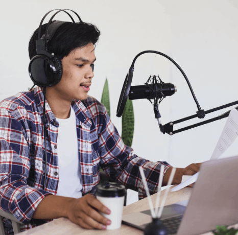 A corporate narrator records E-learning Voiceover Services for a business training program, checking a compliance script.
