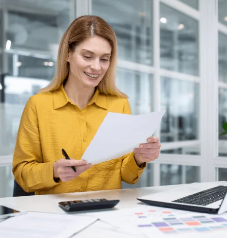 An analyst compares a corporate financial report to its translation as Quick Translation Services keeps tables and figures.