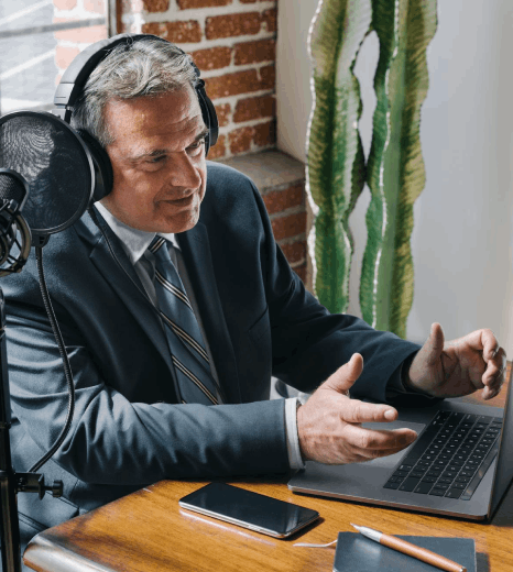 An HR manager reviews Voice Over Styles for a corporate onboarding video while an editor cleans narration audio in studio.